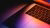 Multi coloured light on half closed laptop