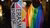 Two people on the streets of Rotterdam, wearing an Erasmus Pride flag and a pride flag, as capes