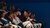 Prospective students sit in a lecture hall.