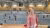 Girl watches children play volleyball from gallery