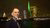Guido Imbens standing in front of green lit Erasmus Bridge