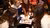 People sitting around a table pointing at a paper