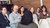 People sat listening to a woman in a hijab