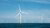 A seascape filled with windmills.