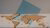 World map made out of art and a blue rectangle in the middle on the background