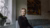 Woman sitting in a living room, looking out the window