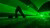 A green ligth emerging from the back and the arms raised by a person dancing