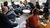 A group of students is seated in a circle to discuss a book