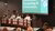 Panel of students with a screen in the background saying 'EdUconnect: Navigating AI in Education'