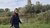Portrait photo of Marja Oberink, she is walking in nature and is passing by a windmill.