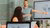 An EUR employee presents in front of a screen
