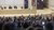 Students are raising their hands in a lecture hall