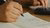 Person writing on paper