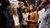 A group of people standing in an elevator looking awkward
