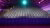 Photograph: empty auditorium with rows of gray seats illuminated by purple and teal lights