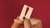 Wooden hand holding an exclamation mark on red background