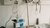 Hospital bed with IV infusion pump, hanging fluid bags and stethoscope on wall