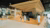 Spacious modern lobby with wooden geometric reception pod (Education Lab).