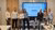 Students standing in front of a screen that reads "Innovation advice for Middin"