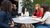 People are sitting around a table.