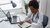 Healthcare Administrator, working at her desk