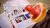 Photo of grapefruit with chili pepper skewered inside, beside pub quiz sheets and pen