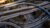 Aerial view of multi-level freeway interchange with train crossing curved ramps