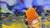 Paintbrush with orange bristles on colorful abstract fluid art background (blue, green, yellow, red)