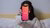 Woman holding a phone with the dating app Tinder showing.