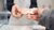 Two pairs of hands exchanging a banknote over a counter
