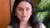 Woman with black hair standing in front of a plant and closet