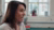 Photograph: woman with brown hair speaking in sunlit office