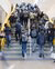 Middle school students walk up the stairs in the hall of their school.