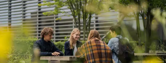 Students sitting at a table at the campus