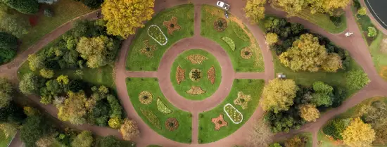 Bird eye view of a green park with a grass circle in the centre