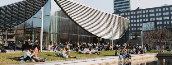 A outside view of the Erasmus Paviljoen with people sitting on the terrace