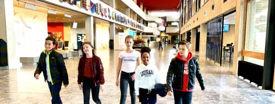 Kids walking through university hall