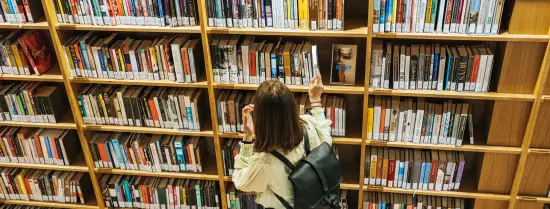 girl in front of a book case