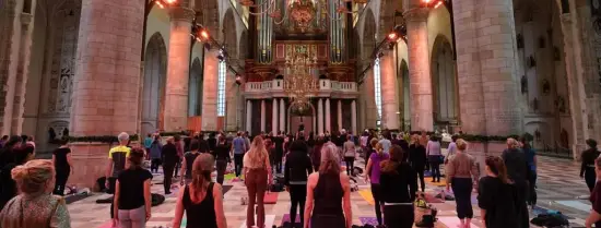 People are taking yoga class in a church