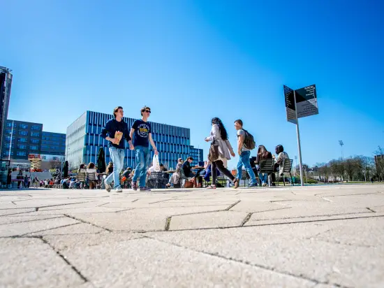 students walk across campus