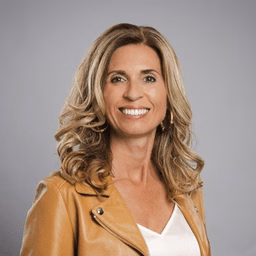 Nicolette smiles into the camera.